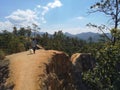 Woman walking peacefully with her little white dog in spectacular landscape