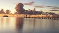 Woman walking on a pier at sunrise in Raiatea