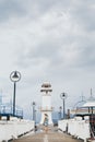 Woman walking on the pier towards lighthouse in Baan Bang Bao fisherman village on Koh Chang island, Thailand