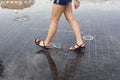 Woman walking on a puddle in the street Royalty Free Stock Photo
