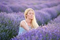 Woman walking between rows of lavender flowers and posing Royalty Free Stock Photo