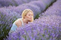 Woman walking between rows of lavender flowers and posing Royalty Free Stock Photo