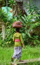 A woman walking on rural road in Bali, Indonesia Royalty Free Stock Photo