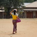 A woman walking on rural road in Mandalay, Myanmar Royalty Free Stock Photo