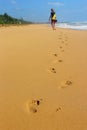 Woman walking on sand beach Royalty Free Stock Photo