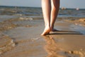 Woman walking on sand beach leaving footprint in the sand. Beach travel