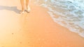 Woman walking on sand beach near wather