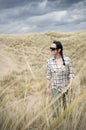 Woman walking in sand dunes Royalty Free Stock Photo