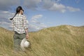 Woman walking in sand dunes Royalty Free Stock Photo