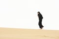 Woman walking by sand hill crest Royalty Free Stock Photo