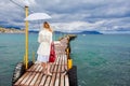 Woman walking on sea footbridge