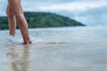 A woman walking in the shallows on the beach Royalty Free Stock Photo