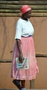 Woman walking on the sidewalk in Victoria Falls in Zimbabwe. Royalty Free Stock Photo