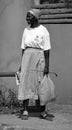 Woman walking on the sidewalk in Victoria Falls in Zimbabwe. Royalty Free Stock Photo