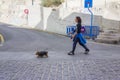 Woman walking a small dog on a leash