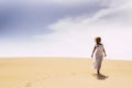 Woman walking in the snd desert dunes alone in freedom leisure activity alone - alternative travel vacation lifestyle - sand Royalty Free Stock Photo