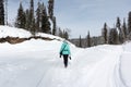 Woman walking on a snow trail, Altai Republic, Russia