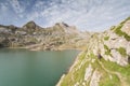 Woman walking in the spanish pyrenees by Estanes lake during sun