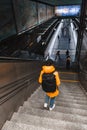 woman walking by stairs down to metro subway underground station