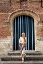 Woman walking medievel Romanesque door