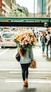 Woman walking in the street carrying a large bunch of flowers obscuring her face