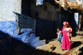 Woman walking in the street of Medina with her kids, Chefchaouen, Morocco