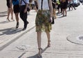 A woman walking on the street wearing floral summer skirt Royalty Free Stock Photo