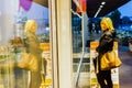 woman walking in the streets admiring shop windows intent on doing shopping