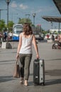 Woman walking with suitcase in front of train station in Mulhouse Royalty Free Stock Photo