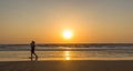 Woman are walking at sunseton Arambol beach, Goa, India