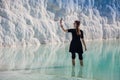 Woman walking on the terraces at Pamukkale. It cotton castle in Turkish and is natural site