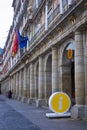 Woman walking towards the I sign for tourist information, Madrid Spain