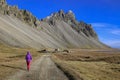 Woman walking towards viking village in Stokksnes under Vestrahorn mountain, Iceland Royalty Free Stock Photo