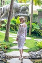 Woman walking in a tropical garden of Bali island, Indonesia.