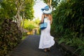 Woman walking in tropical park in early morning