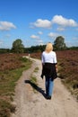 Woman is walking in typical Dutch nature