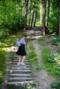 woman walking up by old stairs in forest Royalty Free Stock Photo