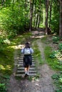 woman walking up by old stairs in forest Royalty Free Stock Photo