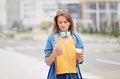 Woman walking and using a smart phone on a city street - Millennial Girl sending a text message using an app on her smart phone Royalty Free Stock Photo