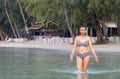 Woman walking in water morning at beach Royalty Free Stock Photo