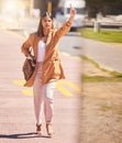 Woman, walking and wave to taxi in city for bus, cab or commute transportation and travel in cbd for business. Person Royalty Free Stock Photo