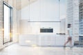 Woman walking in white attic kitchen with island Royalty Free Stock Photo