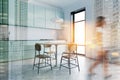 Woman walking in white and green kitchen Royalty Free Stock Photo