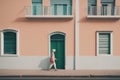 woman walking on a white housewoman walking on a white housea woman in an old town