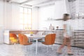 Woman walking in white kitchen with orange chairs Royalty Free Stock Photo