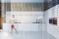 Woman walking in white and wood kitchen, counters Royalty Free Stock Photo