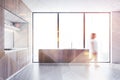 Woman walking in white and wood kitchen Royalty Free Stock Photo