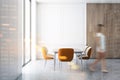 Woman walking in white and wooden dining room Royalty Free Stock Photo