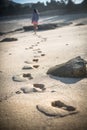 Woman Walks Alone on a Deserted Beach Royalty Free Stock Photo