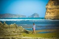 Woman Walks Alone on a Deserted Beach Royalty Free Stock Photo